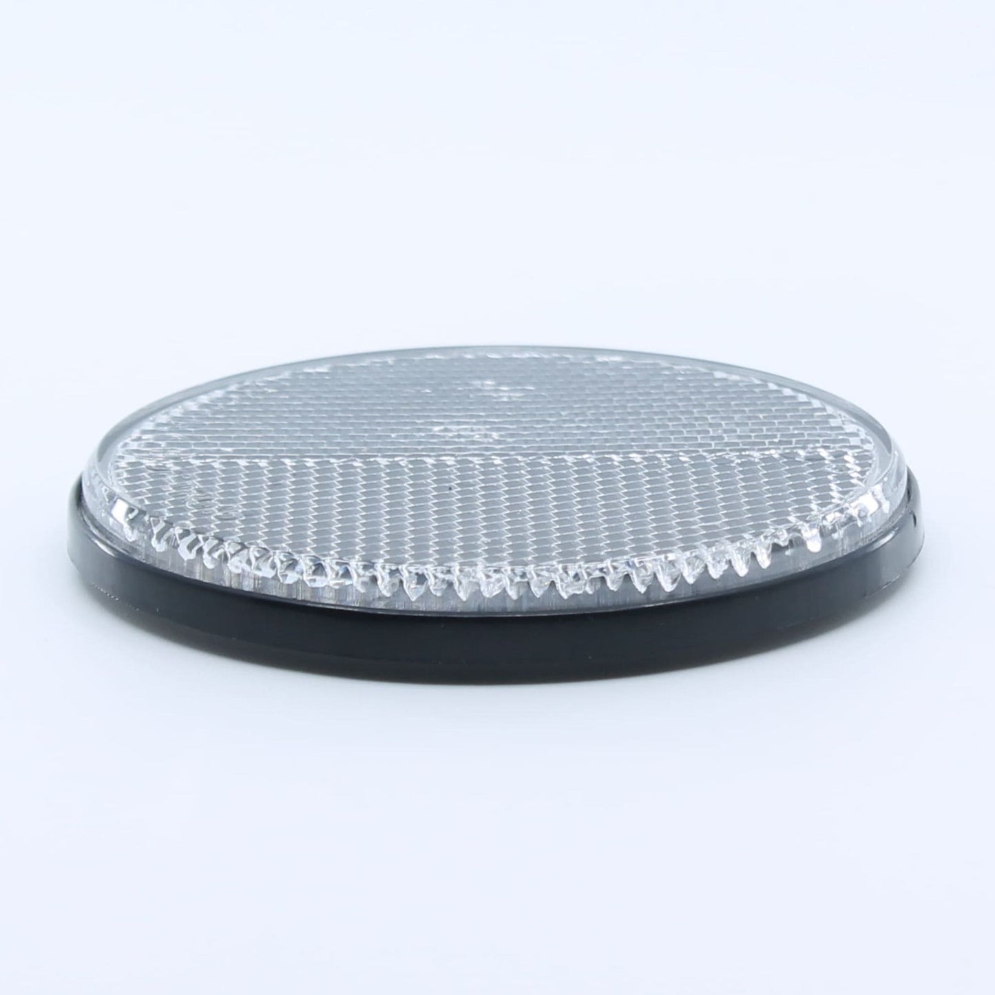 Reflector de seguridad de forma redonda y color blanco, para montaje frontal con fijación adhesiva, utilizado en remolques y maquinaria agrícola.