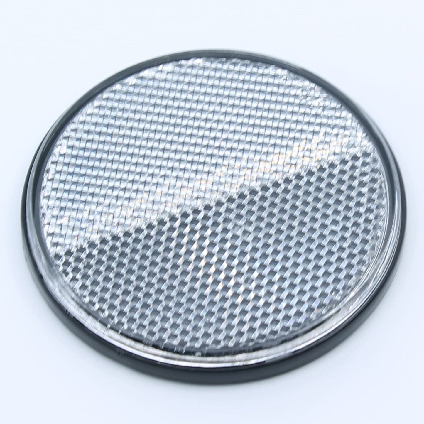 Reflector de seguridad de forma redonda y color blanco, para montaje frontal con fijación adhesiva, utilizado en remolques y maquinaria agrícola.