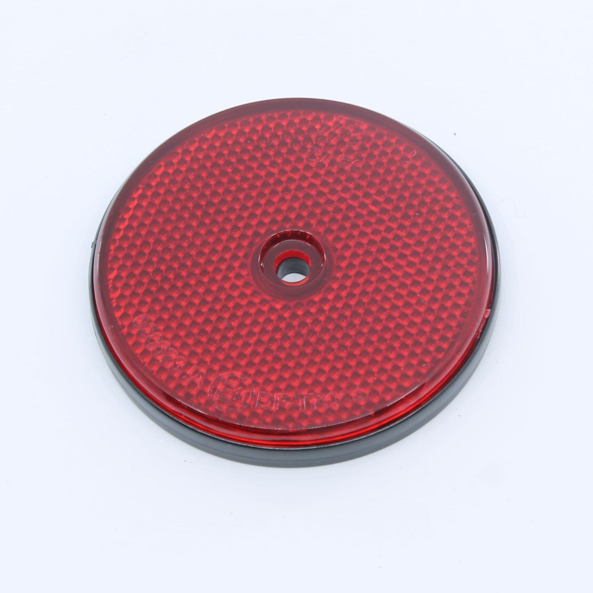Reflector de seguridad de forma redonda y color rojo, con fijación de atornillar, utilizado como señalización trasera en remolques y maquinaria agrícola.